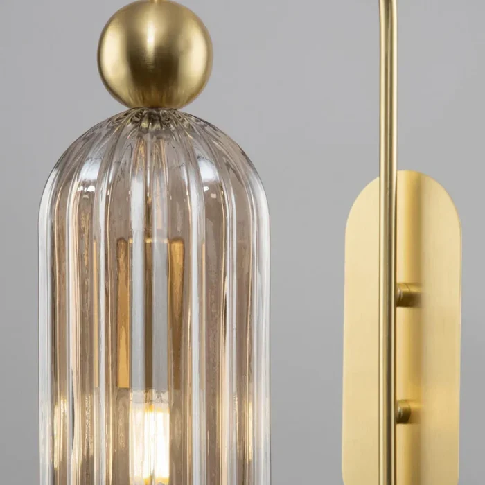 Clear ribbed glass cylinder and gold backplate detail