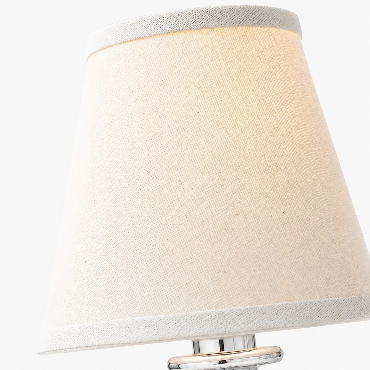 White linen shade texture on a brass sconce