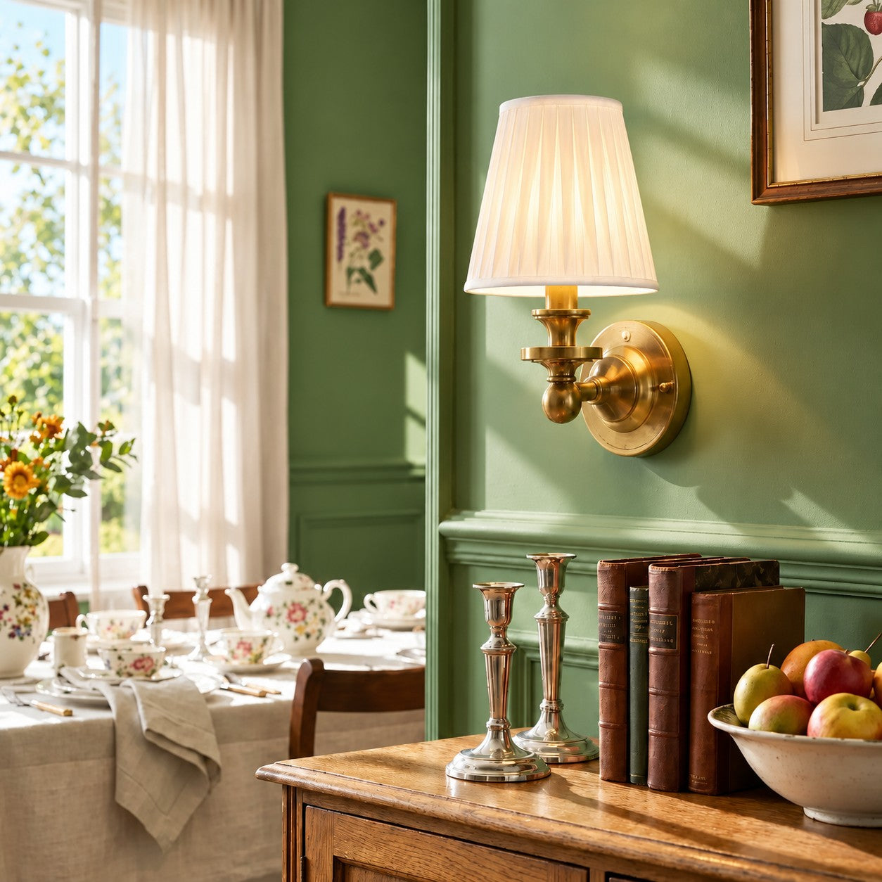 Brass Kalvora wall sconce on a sage green paneled wall
