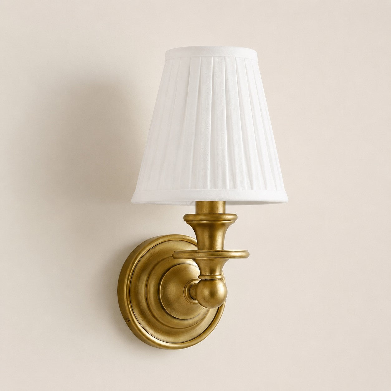 White Pleated Kalvora fabric shade wall sconce in Brass