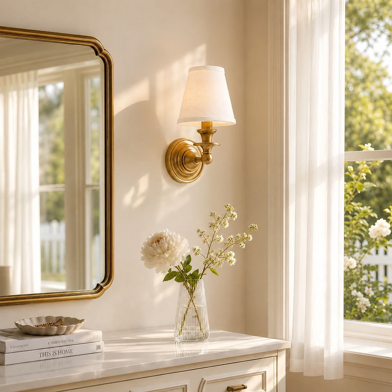 Brass Kalvora wall sconce over a marble-top dresser