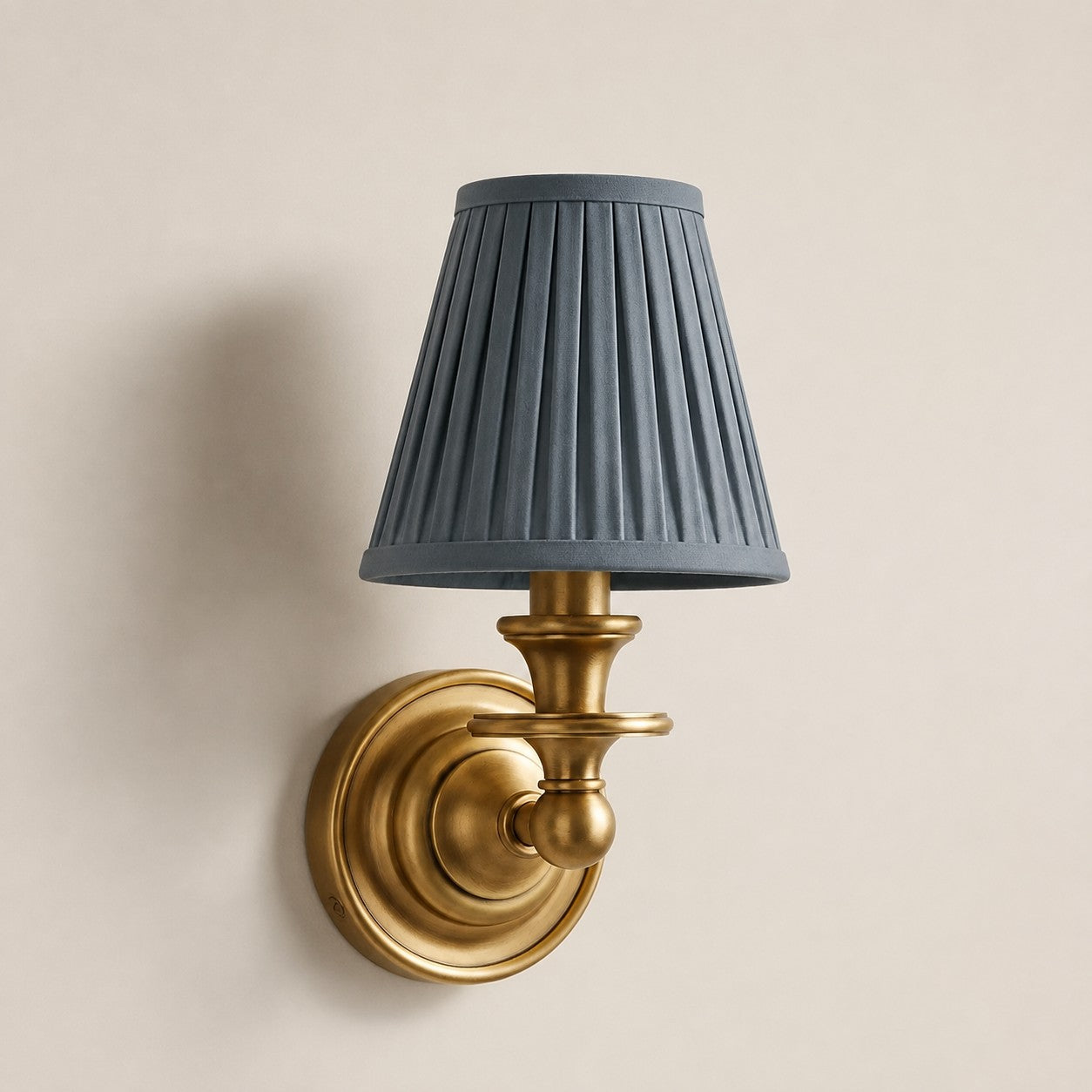 Dusty Blue Pleated Kalvora fabric shade wall sconce in Brass
