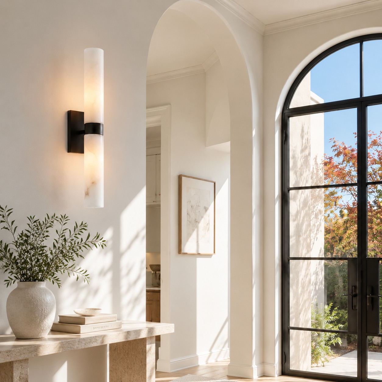 Dani matte black alabaster sconce in an arched entry