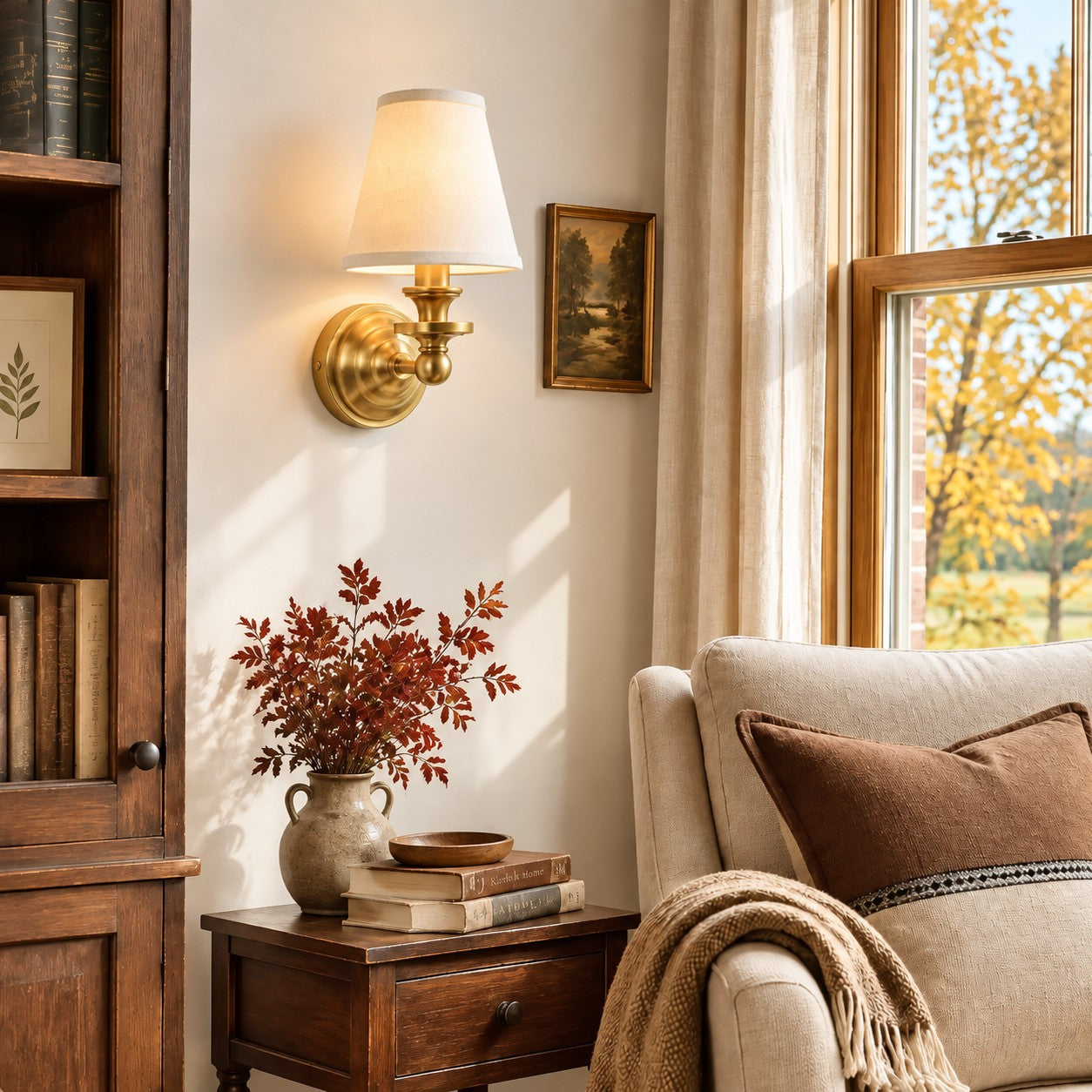 Brass Kalvora wall sconce over a dark wood side table