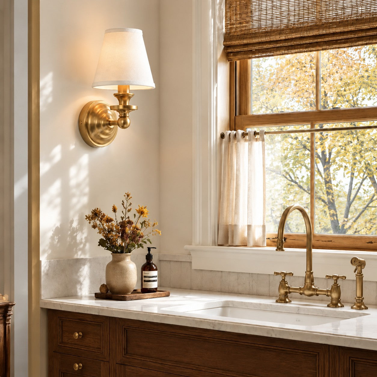 Brass Kalvora wall sconce above a marble sink