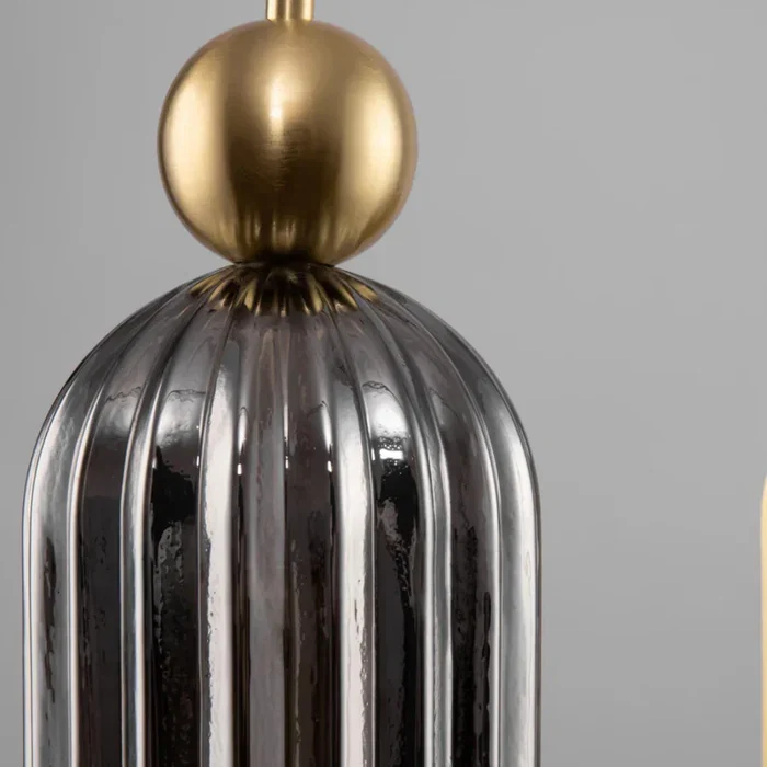 Gray ribbed glass and gold sphere detail
