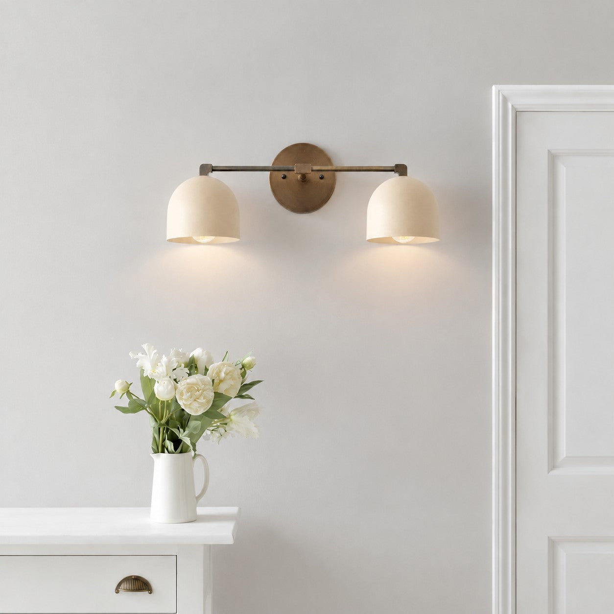 White 2-lights Metio wall lamp over a dresser