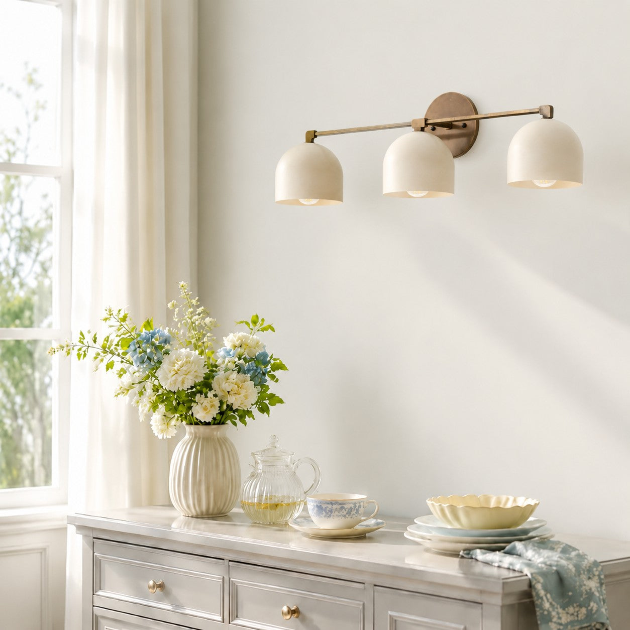 White 3-lights Metio wall lamp over a sideboard