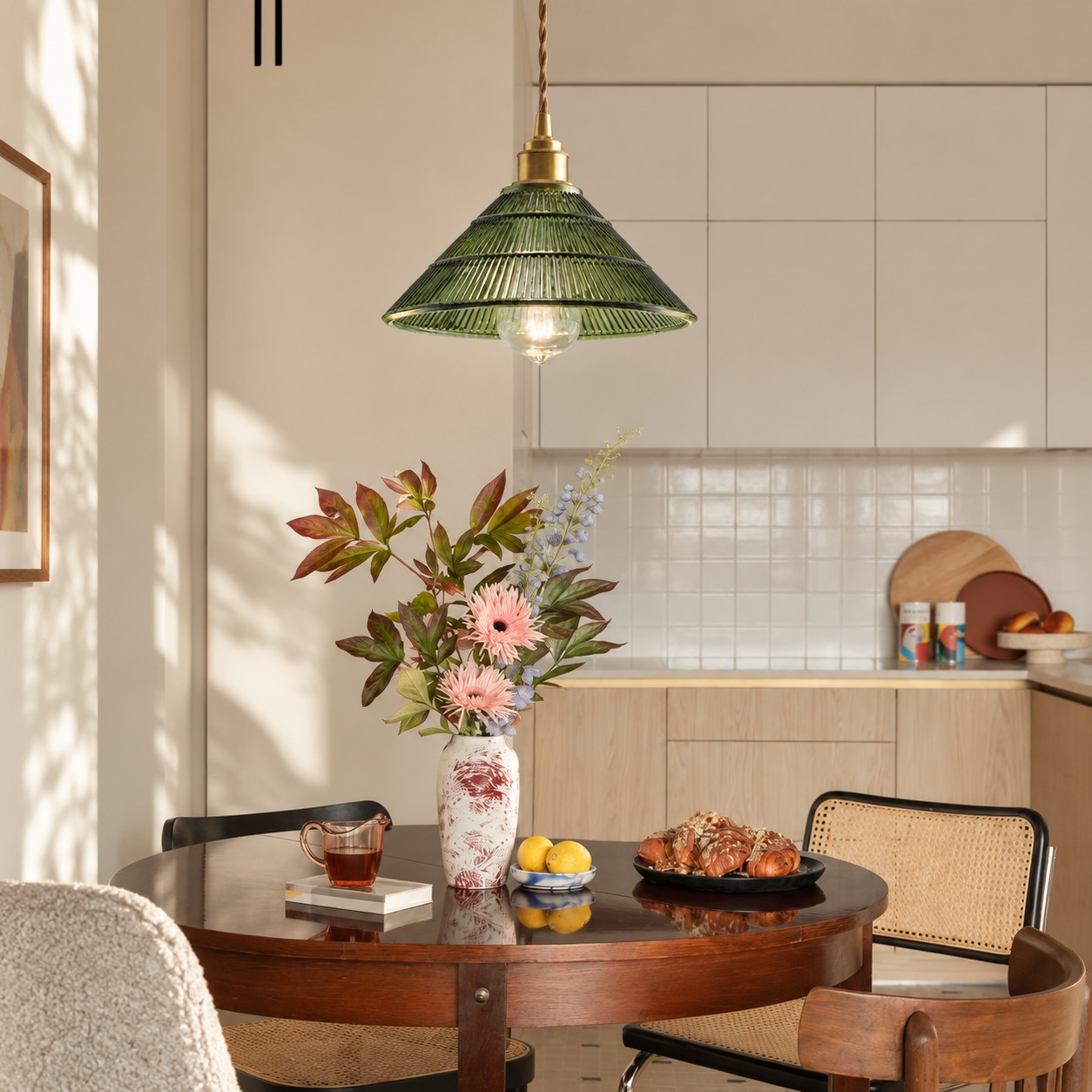 Green pendant light over a dining table