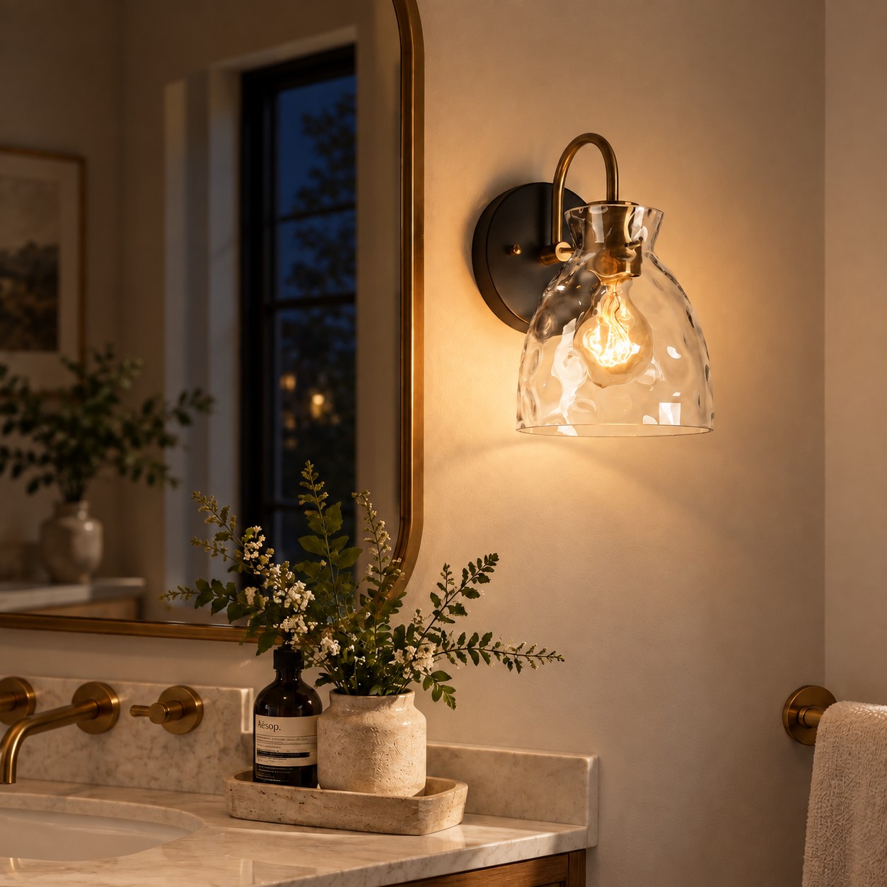 Textured Glass Wall Sconce with a clear shade and a curved arm