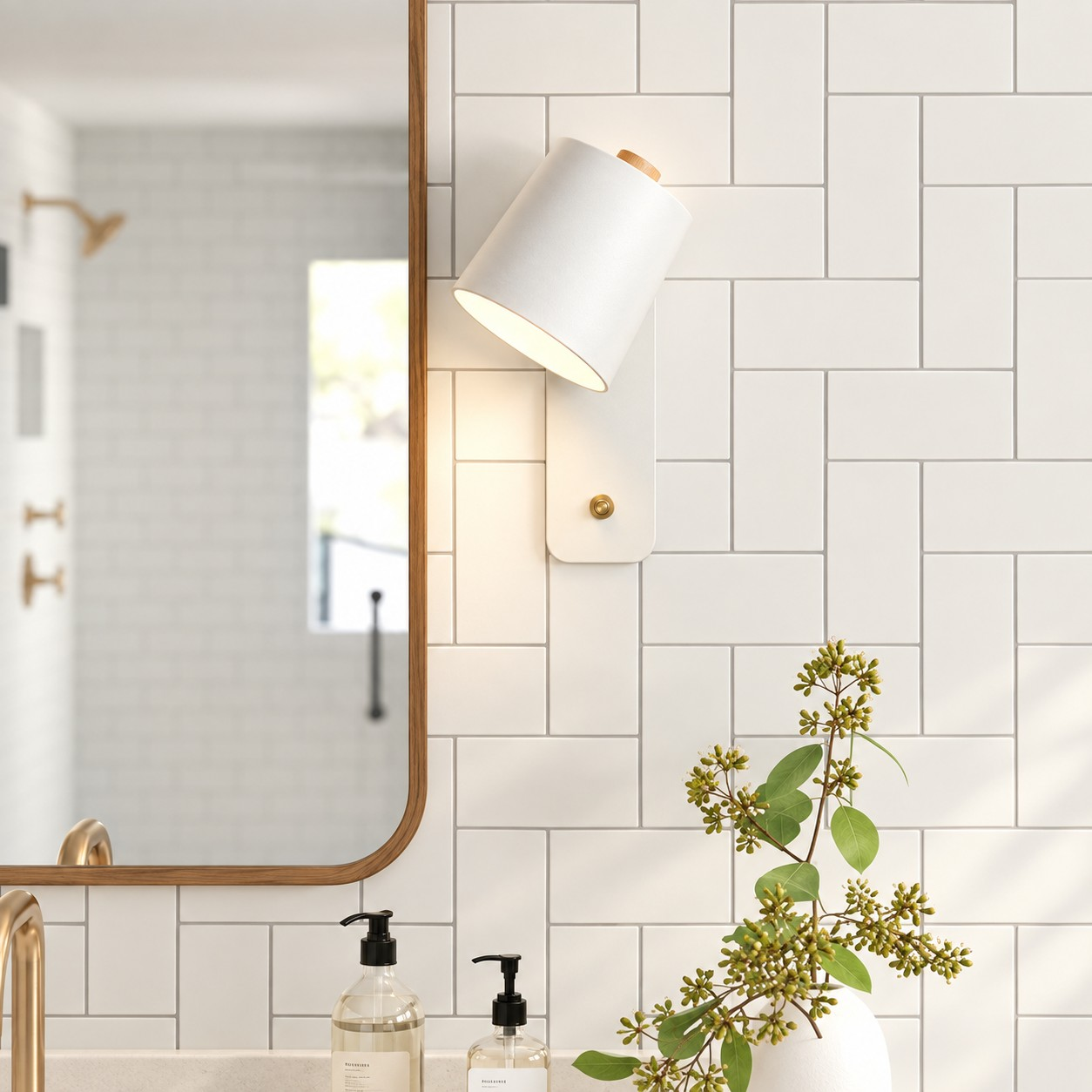 White Proteus wall light beside a bathroom mirror