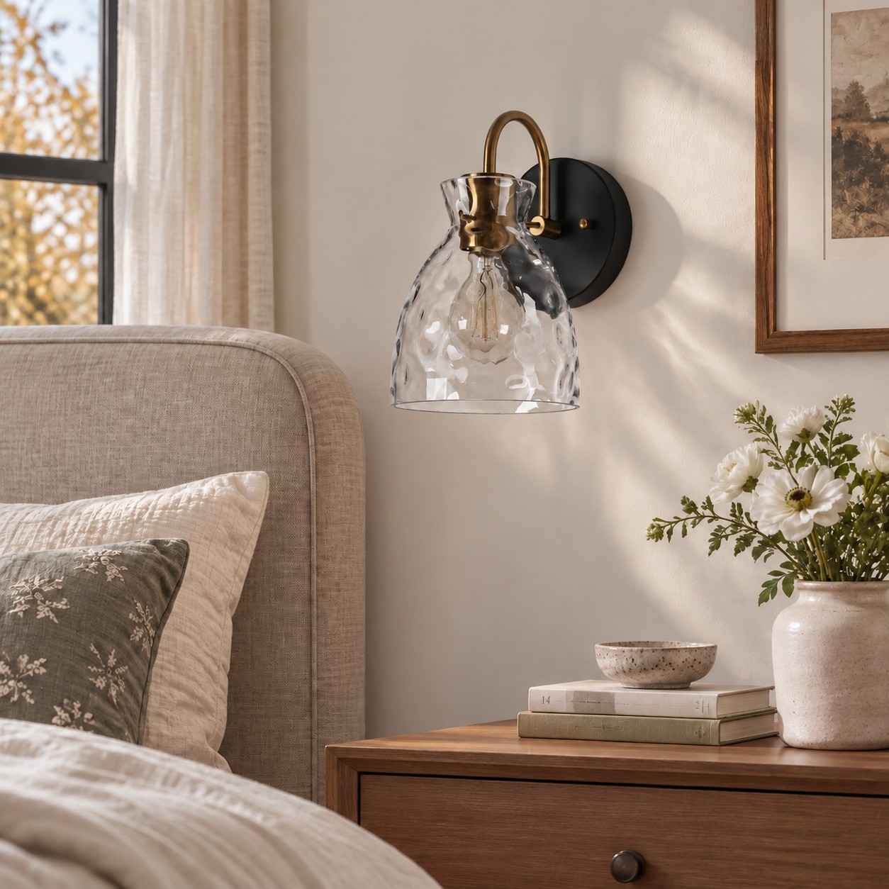 Textured Glass Wall Sconce with a clear shade and a curved arm