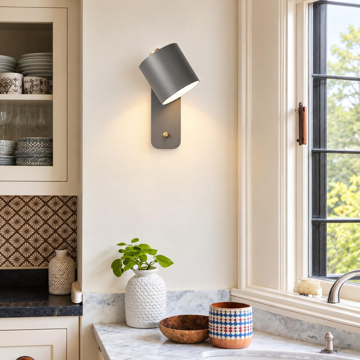 Gray Proteus wall light beside a kitchen window
