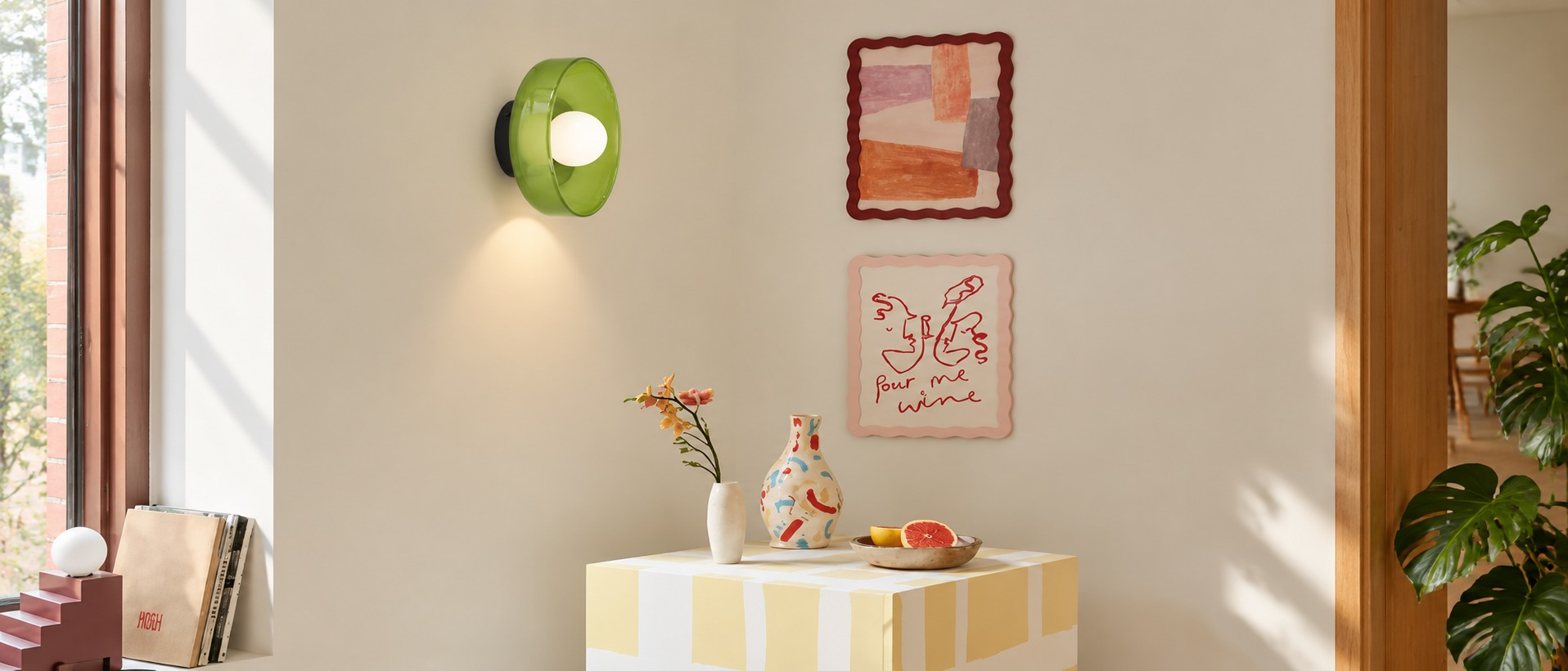 Green glass disc wall sconce beside a console