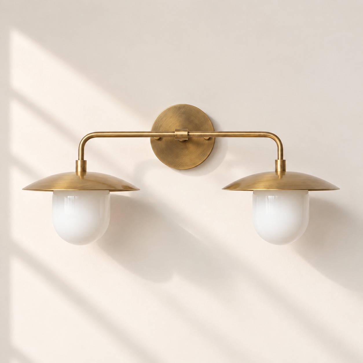 Sculptural Glass Wall Sconce with a brass finish and one to three lights