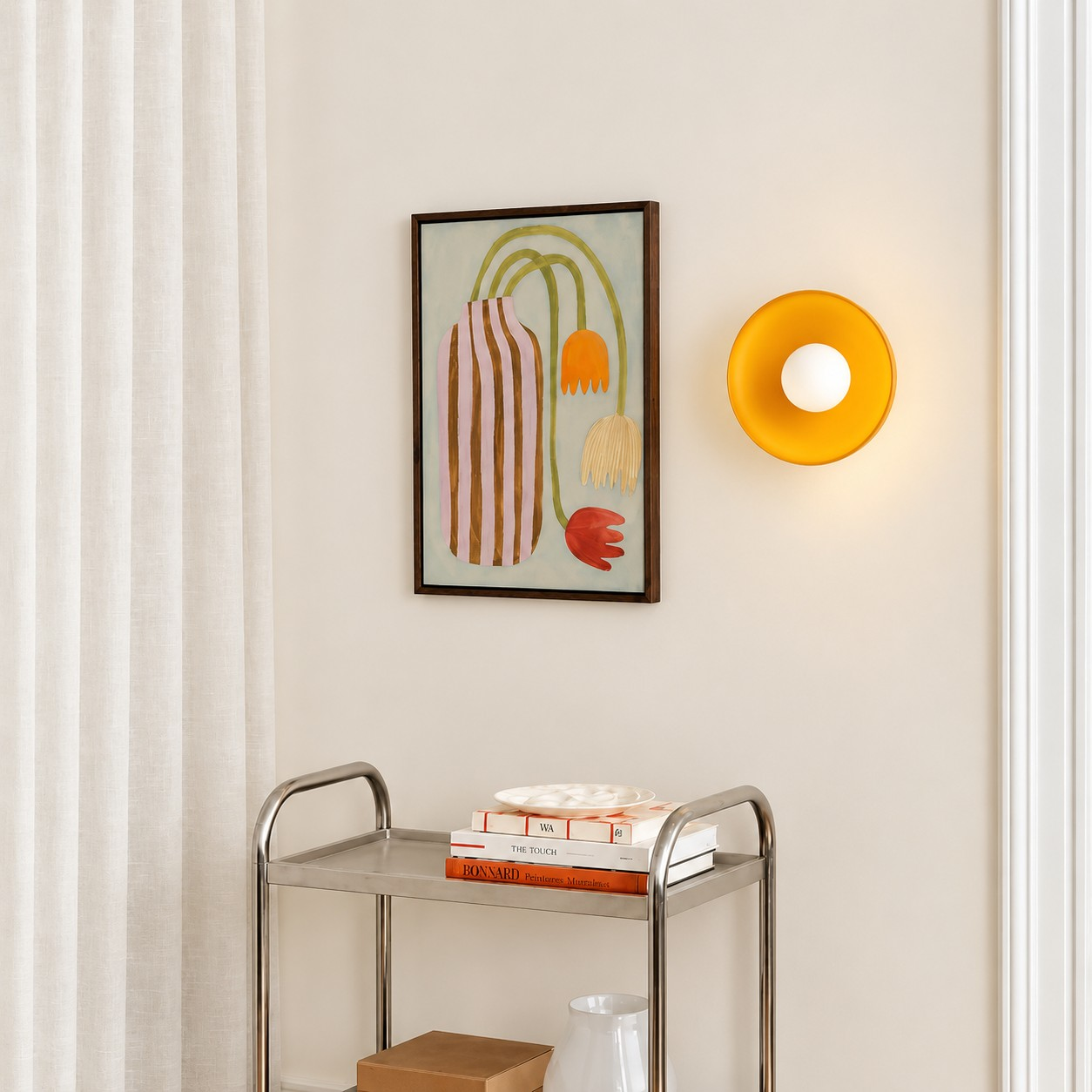 Yellow glass disc wall sconce beside a console