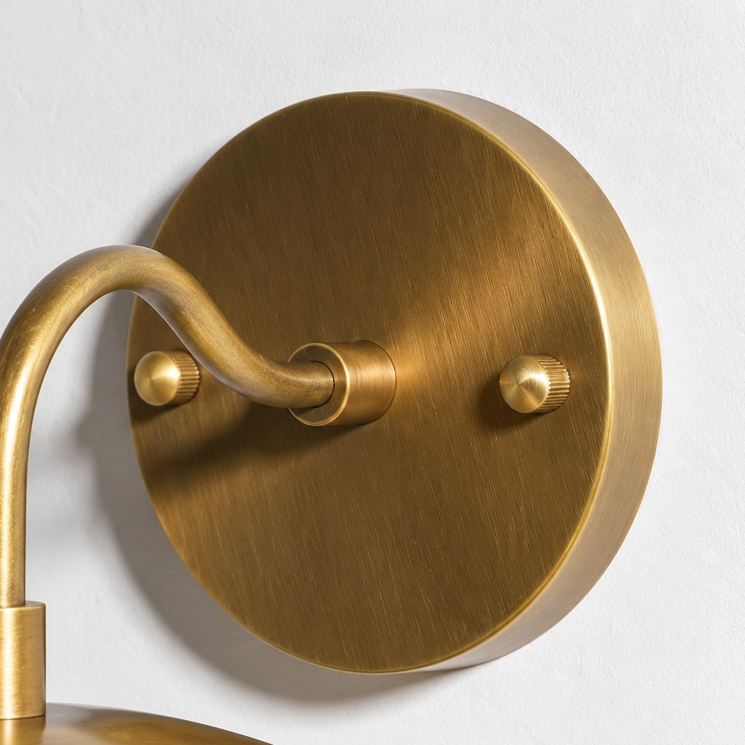 Sculptural Glass Wall Sconce with a brass finish and one to three lights