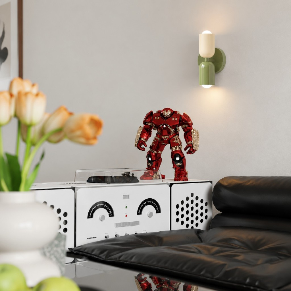 Cream and green capsule wall sconce above a sofa