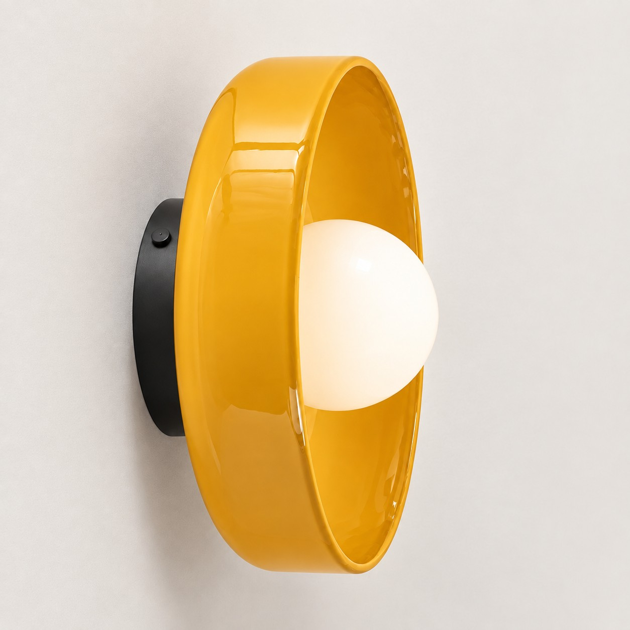 Yellow glass disc wall sconce
