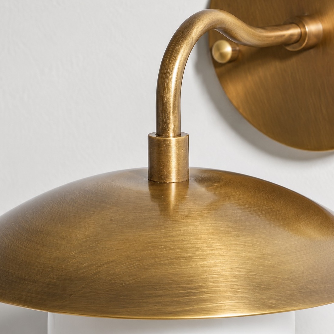 Sculptural Glass Wall Sconce with a brass finish and one to three lights
