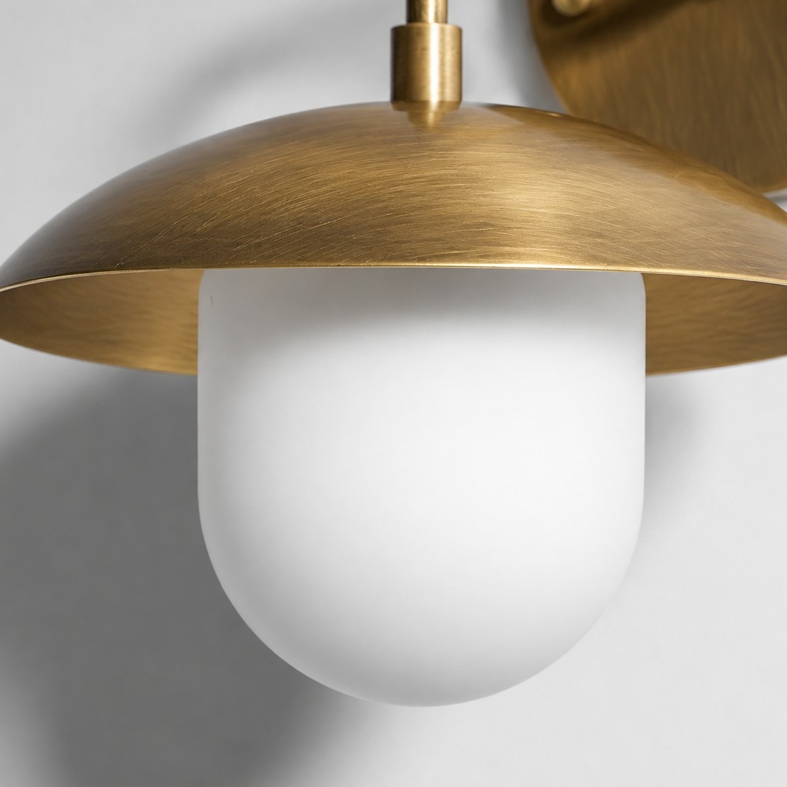 Sculptural Glass Wall Sconce with a brass finish and one to three lights