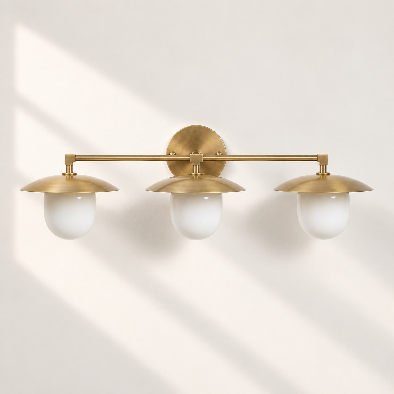Sculptural Glass Wall Sconce with a brass finish and one to three lights