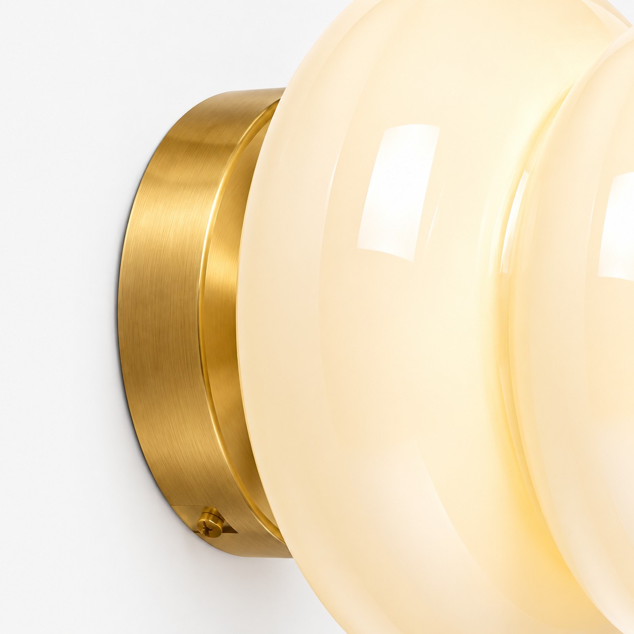 Pyris brushed brass wall plate and opal glass edge detail