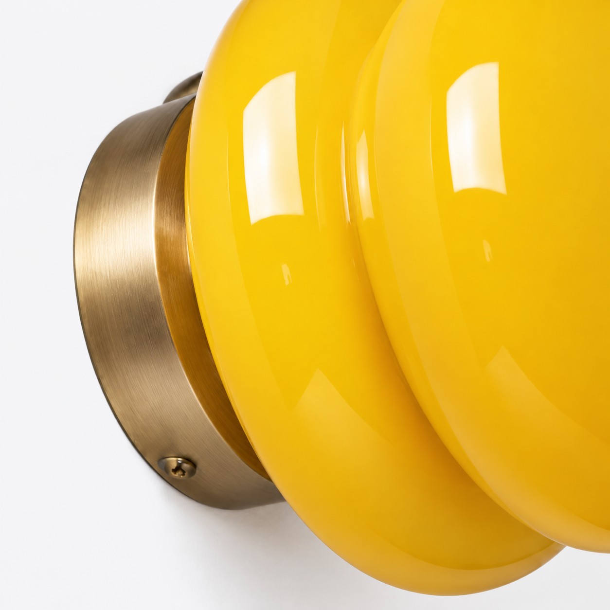 Pyris mustard yellow glass and brass wall plate detail