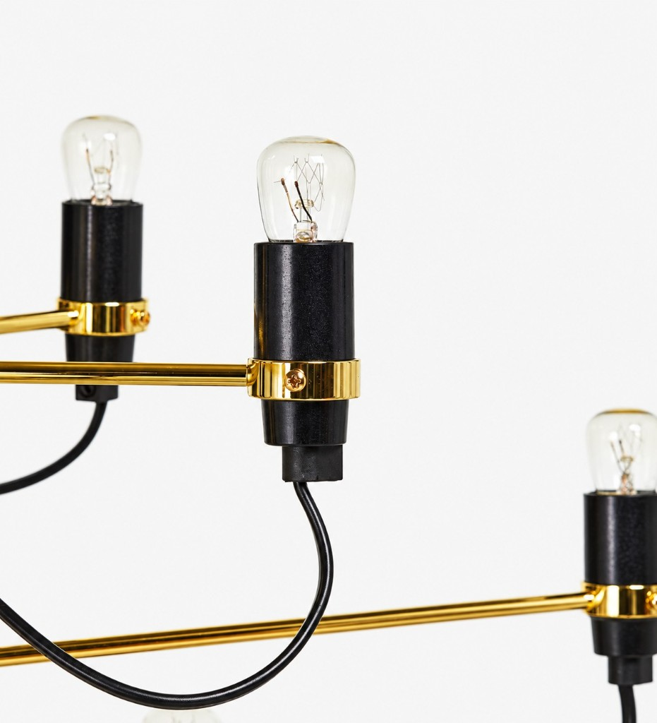 Brass arm, black socket, and clear bulb