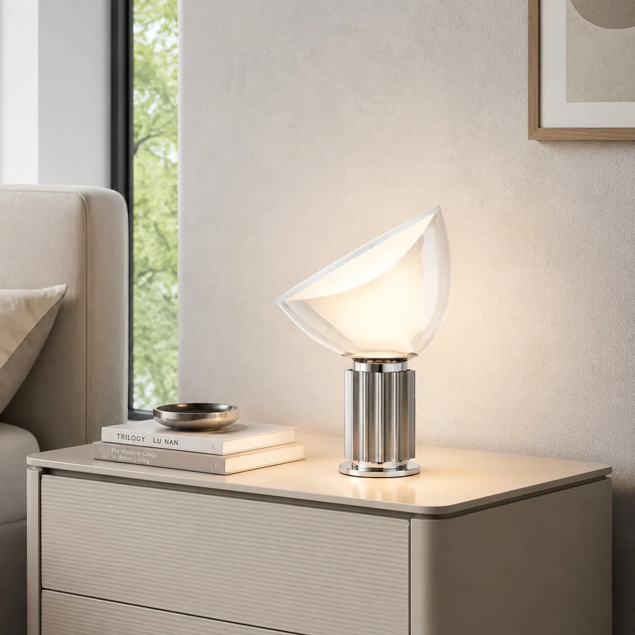 Silver Taccia lamp on a warm bedside cabinet