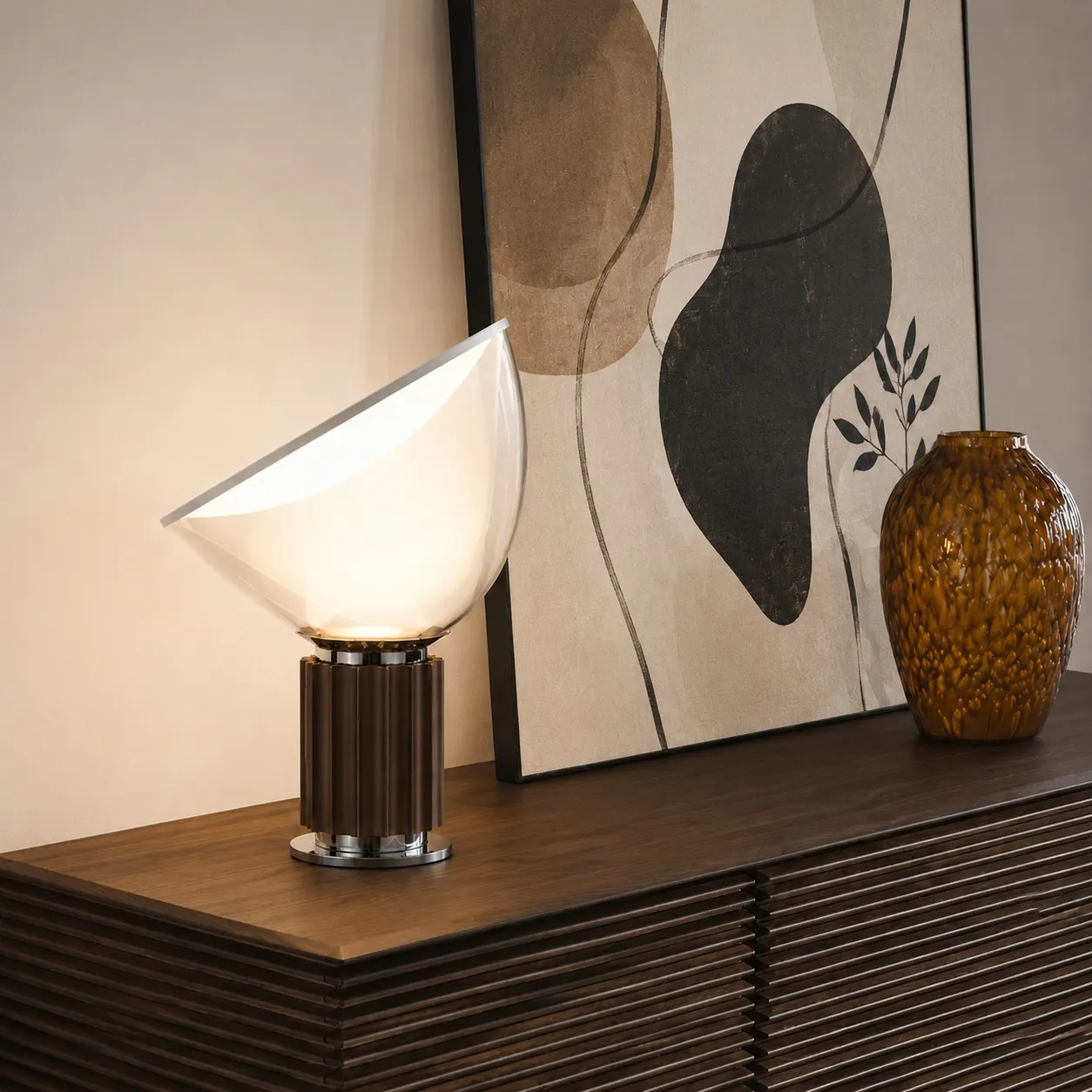 Bronze Taccia lamp beside abstract artwork