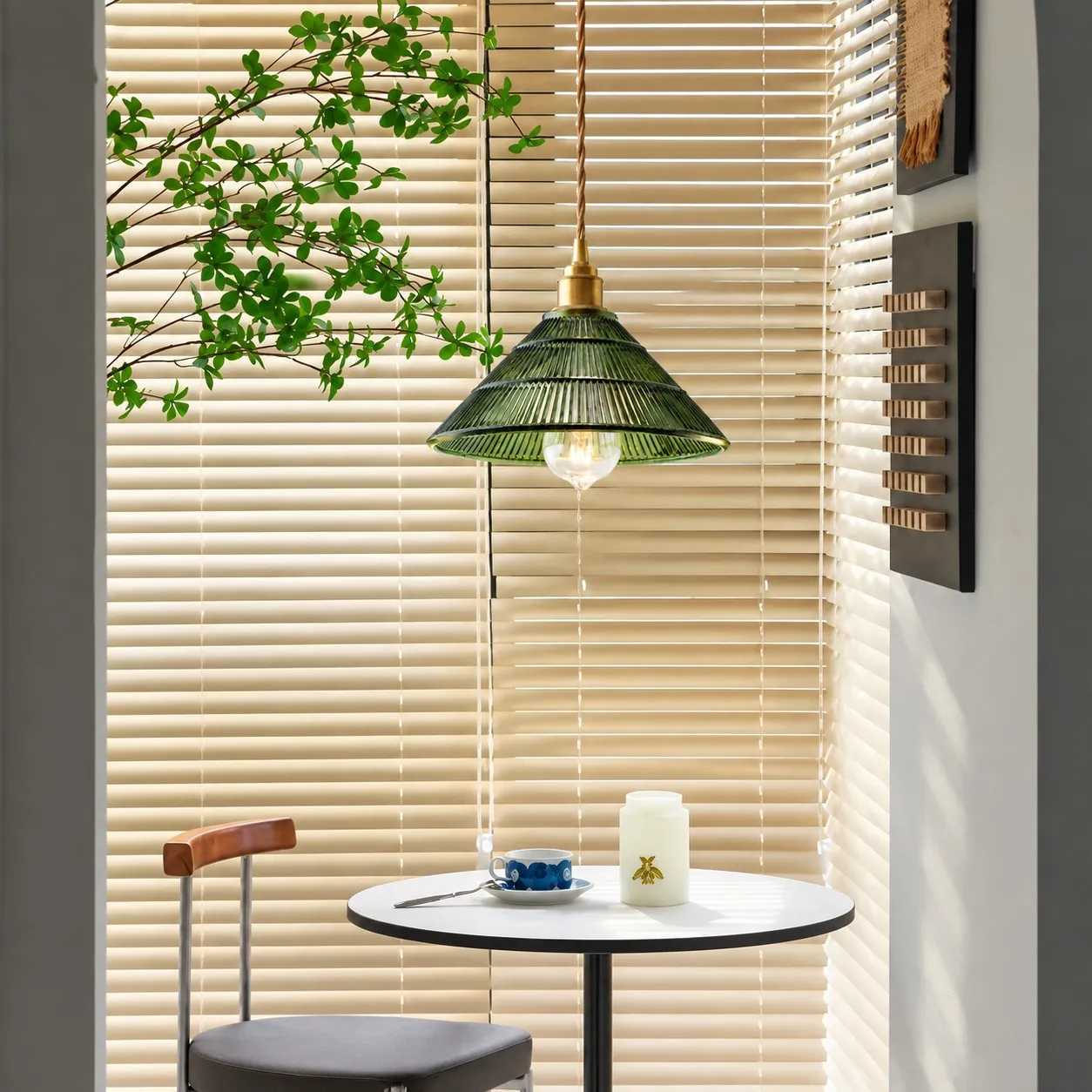 Green pendant light beside a bright window