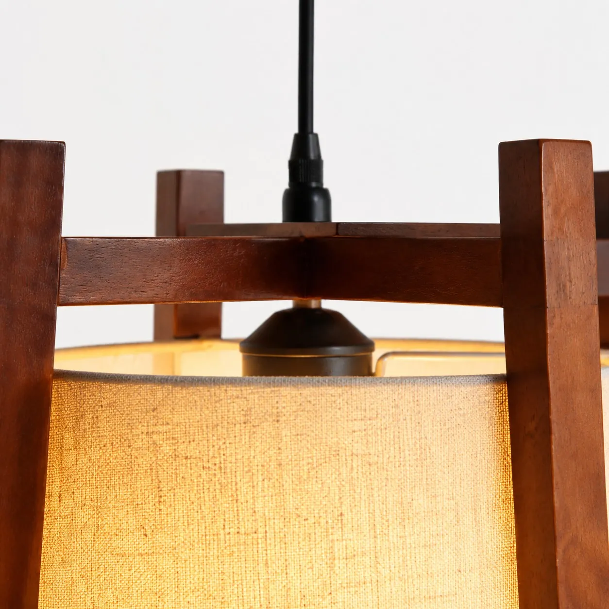 Close-up of walnut finish top frame and black cord
