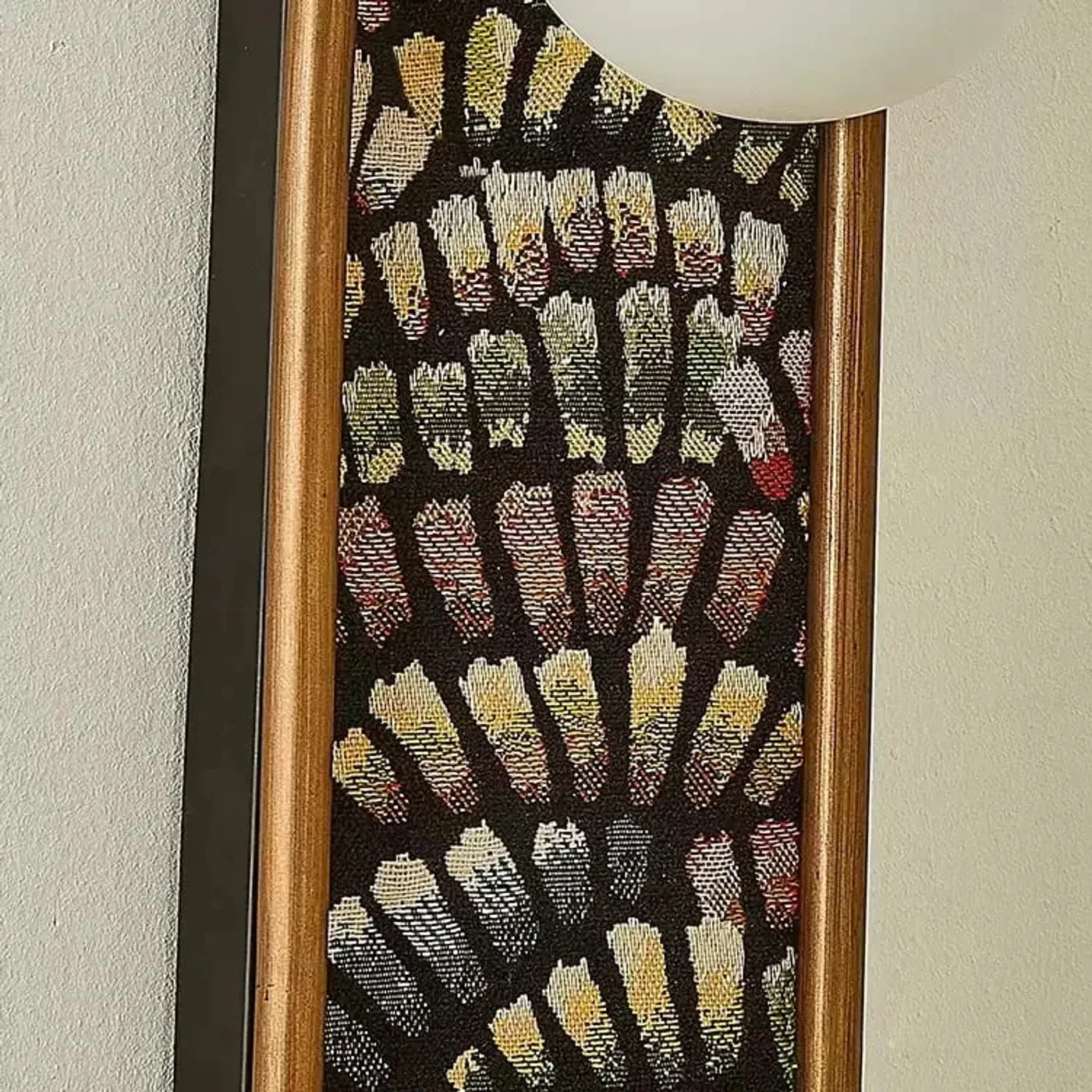 Close detail of fabric panel and warm metal edge