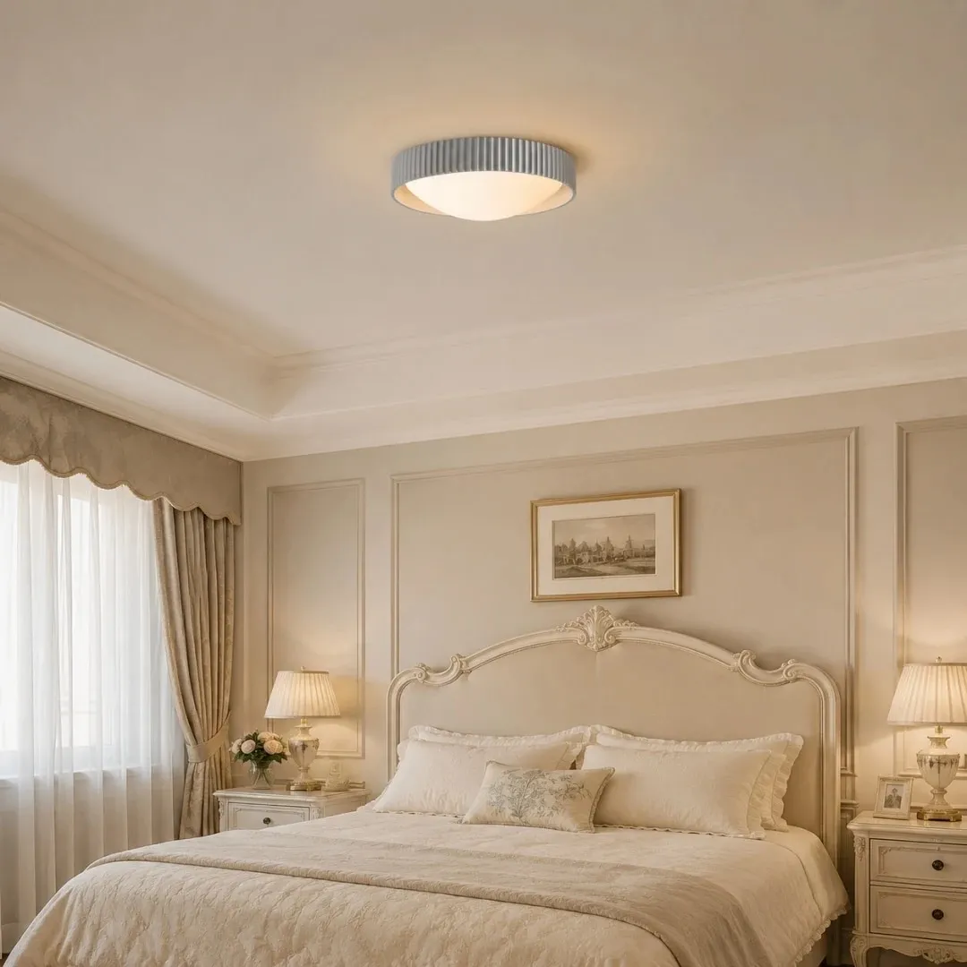 Gray flush mount ceiling light in a soft bedroom setting