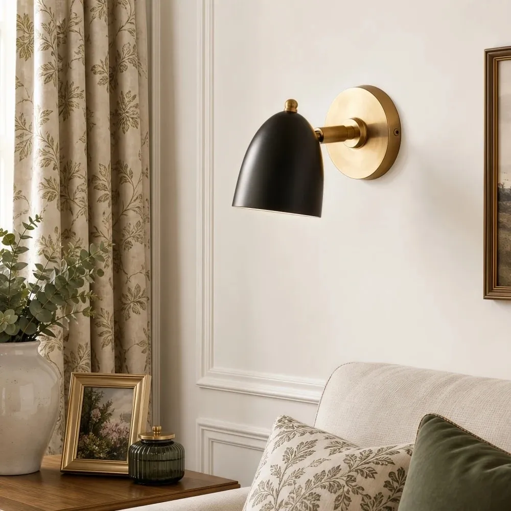 Black and gold wall sconce in a styled room