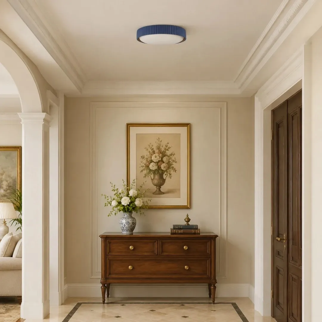 Blue flush mount ceiling light installed in a cream hallway