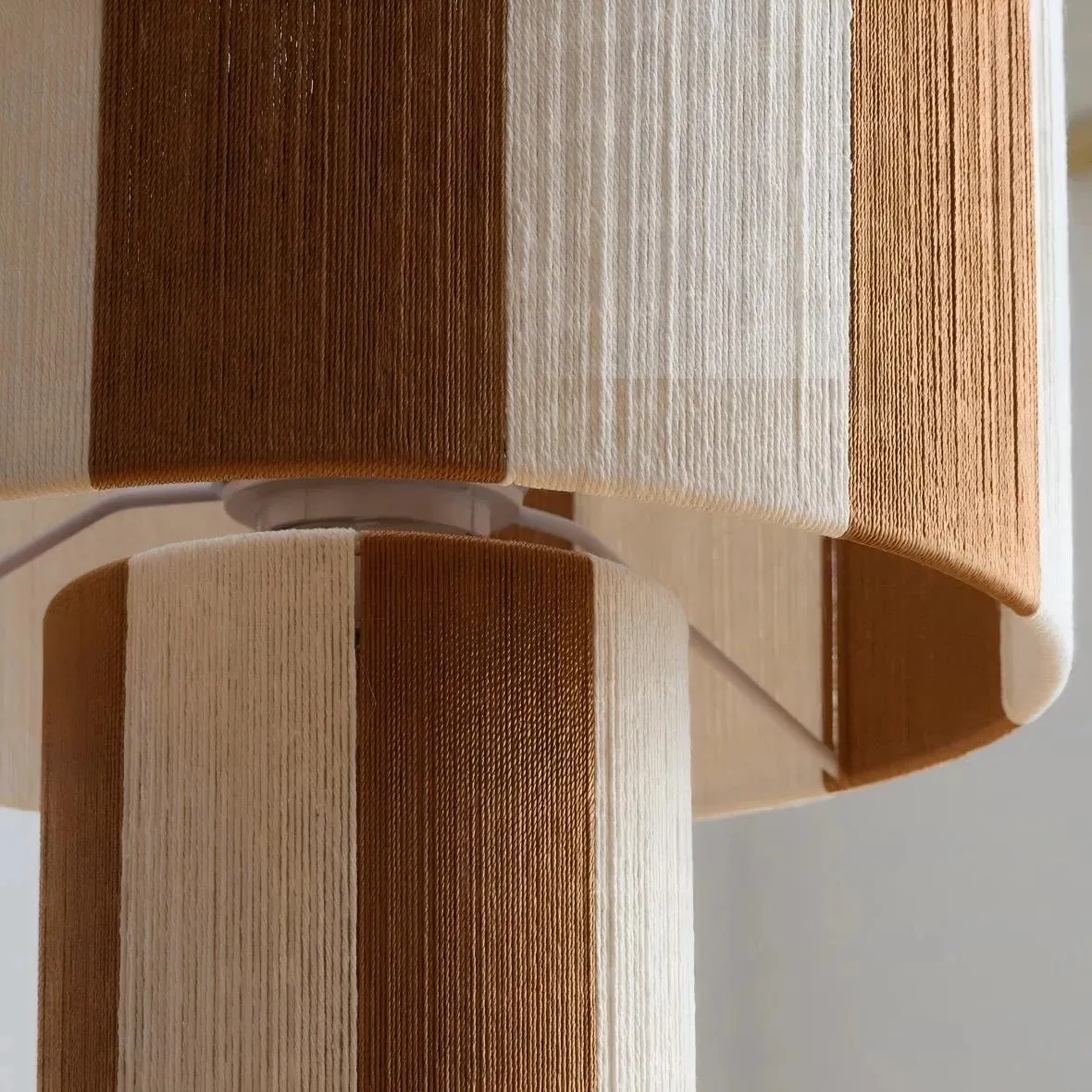 Close detail of the woven striped lamp shade texture and layered panels