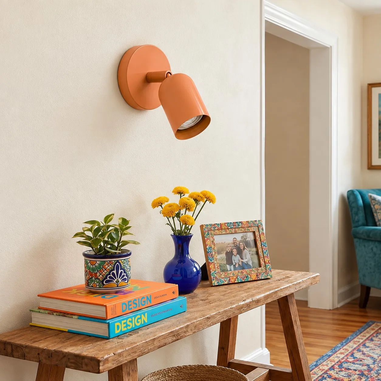 Ares orange-pink wall light above a console