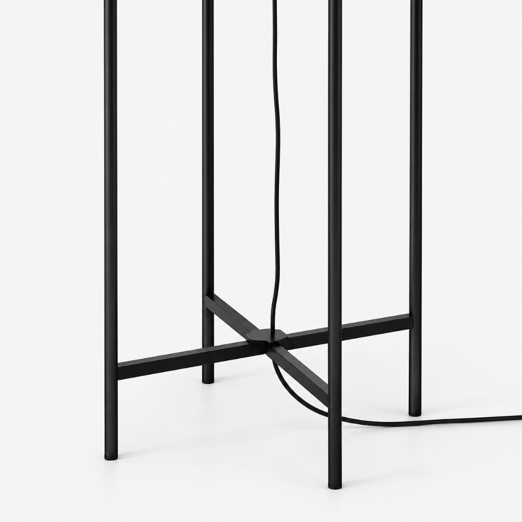 Black metal cross base of the glass globe floor lamp