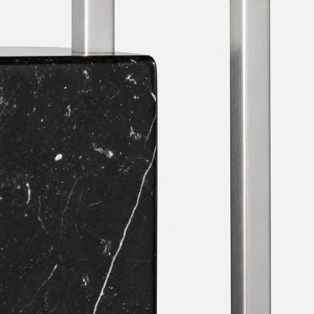 Black marble base and brushed metal stem close-up