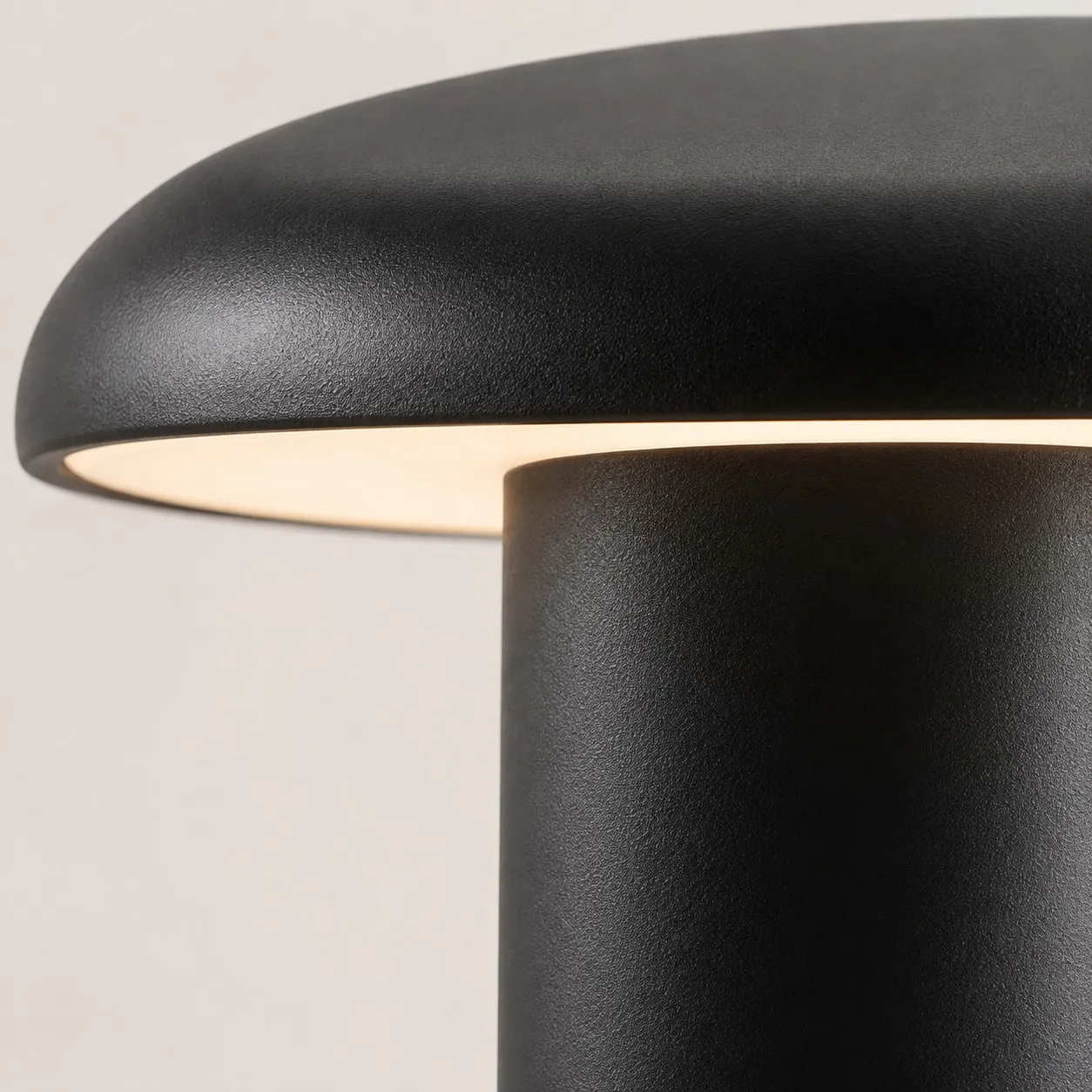 Takku portable table lamp underside diffuser emitting warm light