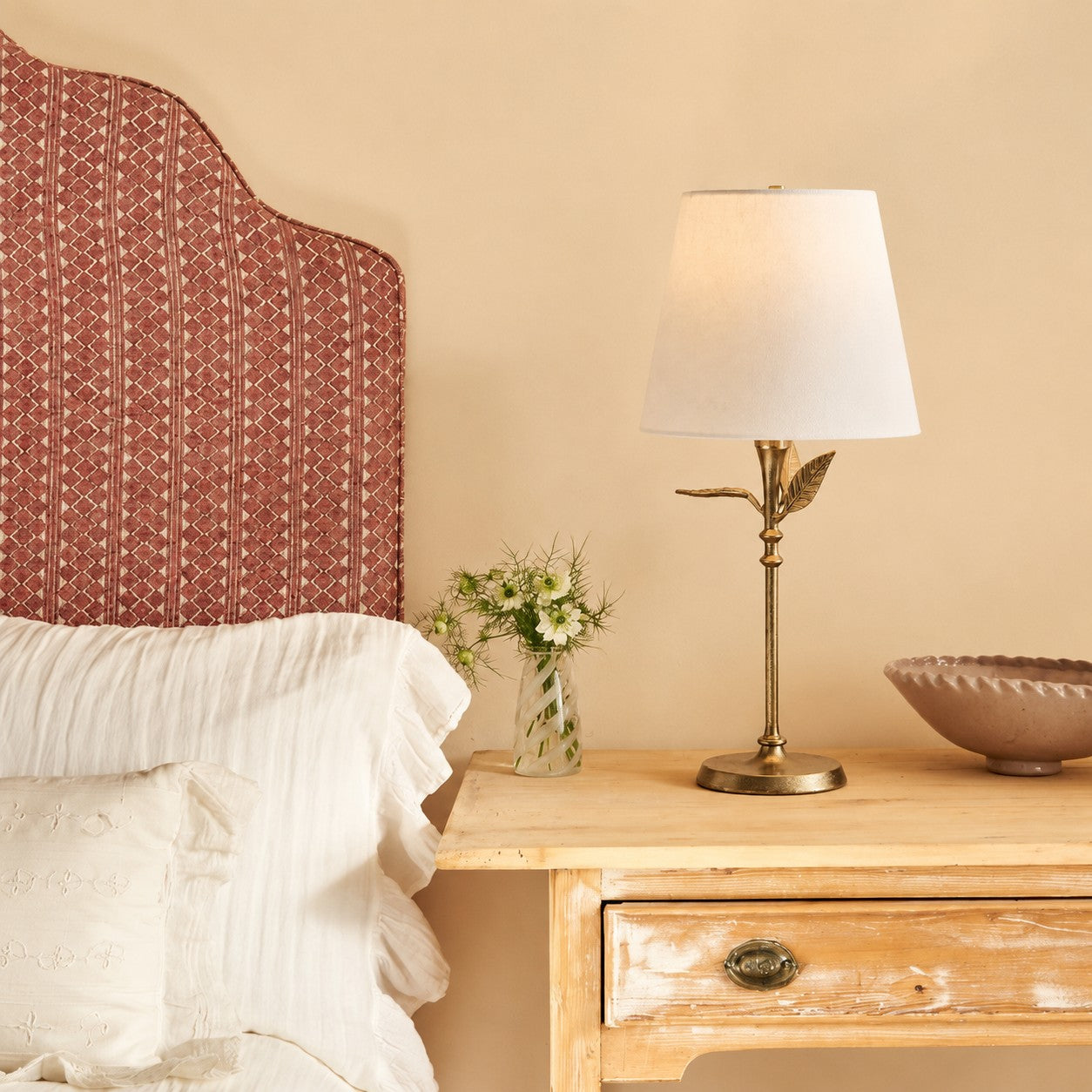 Botanical table lamp on a wooden bedside table