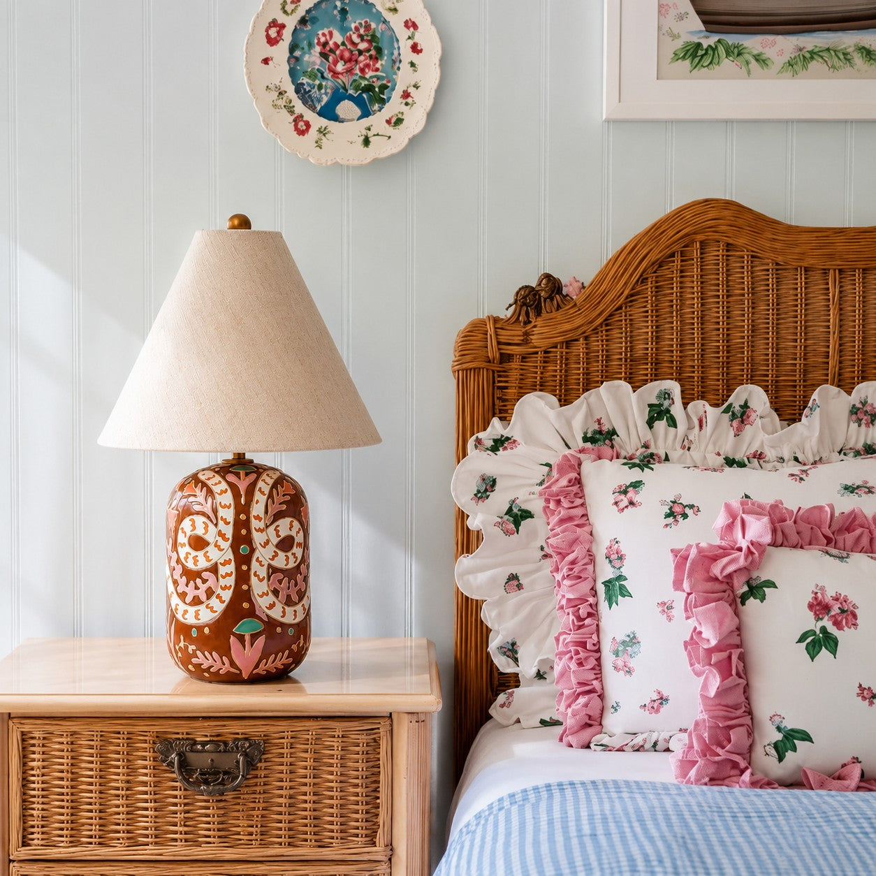 Brown tapered linen shade table lamp beside a wicker bed