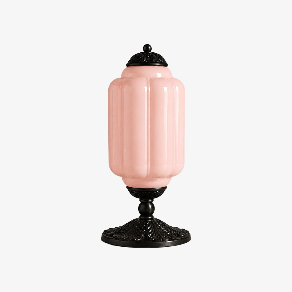 Pink scalloped glass table lamp with a black base