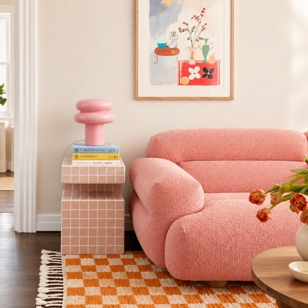 Pink mushroom glass table lamp on a tiled side table