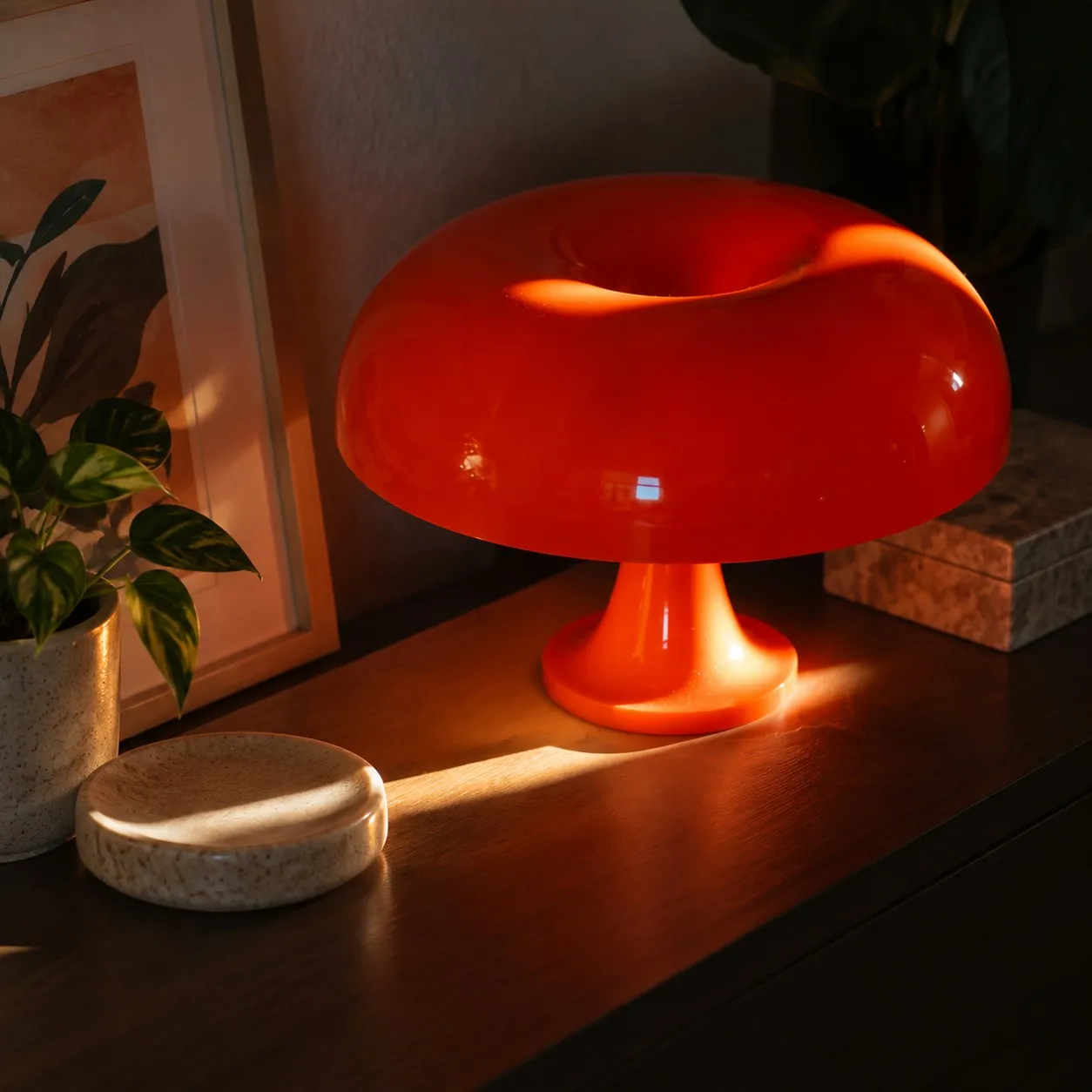 Orange Nessino table lamp on a red and pink geometric cube