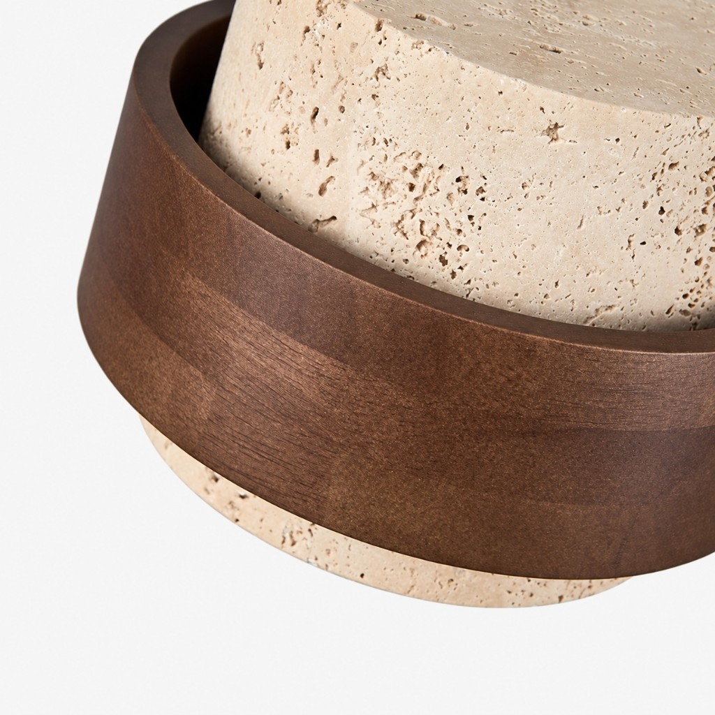 Dark walnut band meeting the travertine