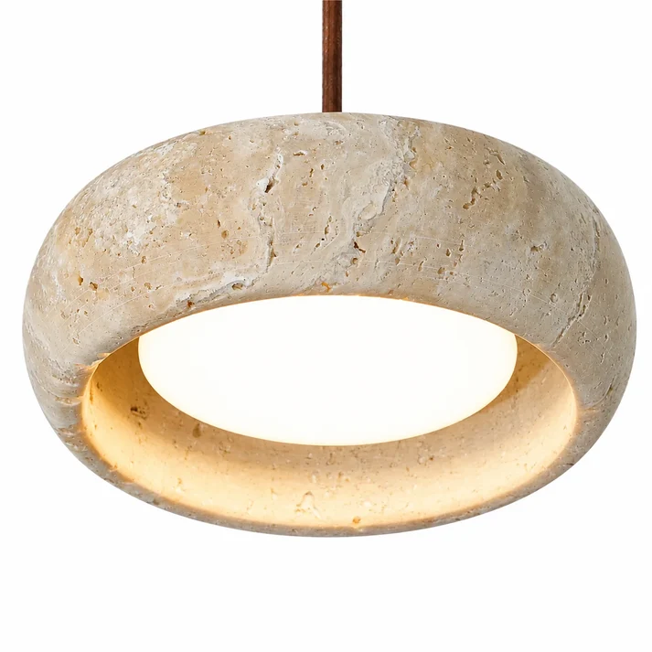 Warm light inside a cream travertine shade