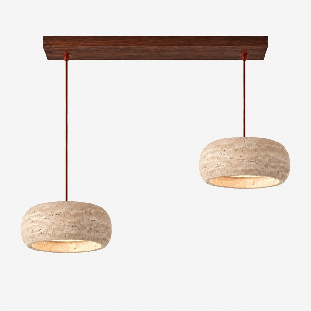 Two large cream travertine rounded pendants on a walnut bar
